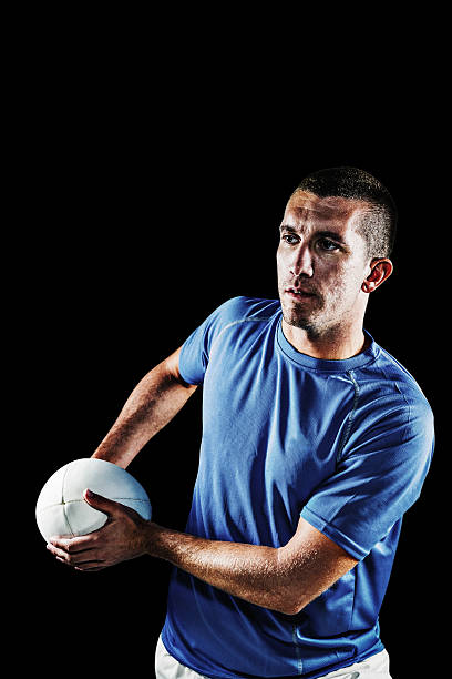 istock Composite image of rugby player looking away while holding ball 490665366
