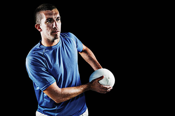 istock Composite image of rugby player looking away while holding ball 490665698