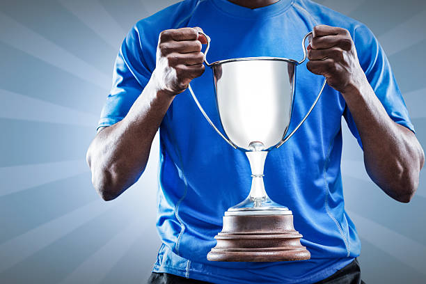 istock Composite image of rugby player holding winners cup 490666172