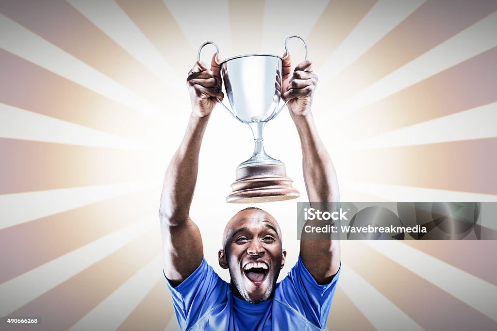 Composite image of happy athlete cheering while holding trophy Happy athlete cheering while holding trophy against linear design 20-24 Years Stock Photo