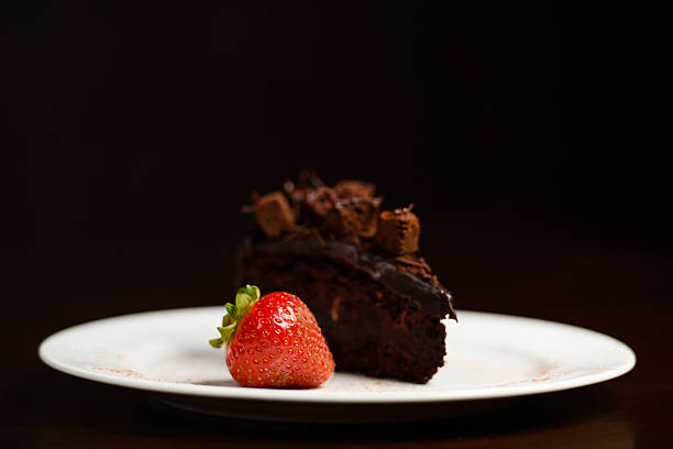Plated and served indian food.Plated slice of cake with strawbery.