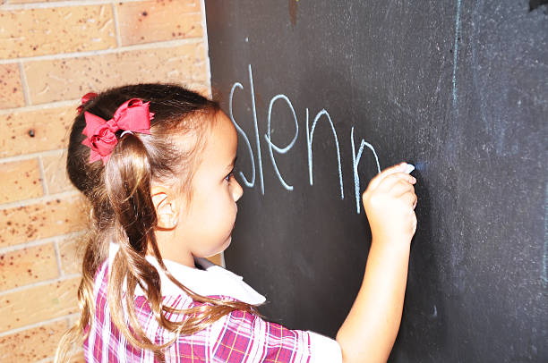 istock School girl writing her name 490666822