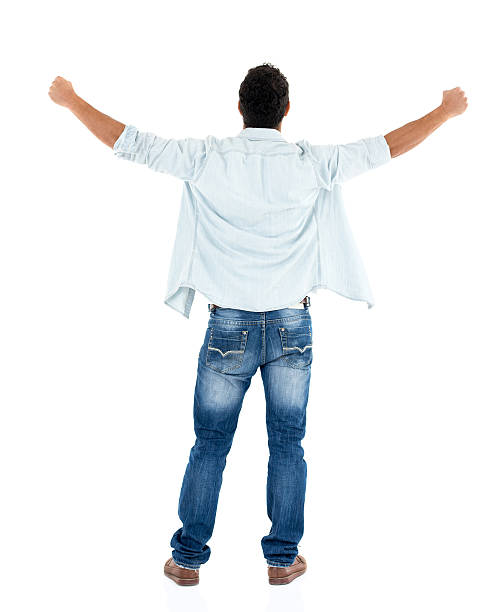 Full body man turning his back to the camera celebrating an achievement with arms up