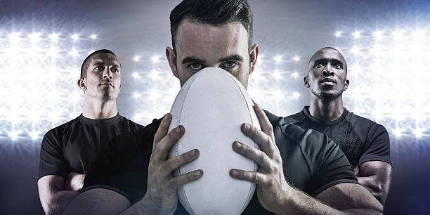 istock Composite image of tough rugby player holding ball 490667582