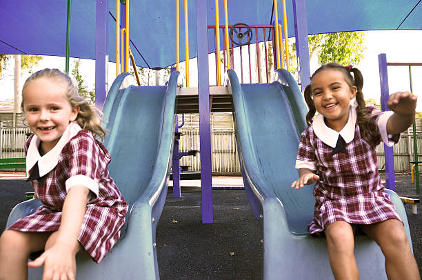 istock Happy girls on slippery dip 490667606