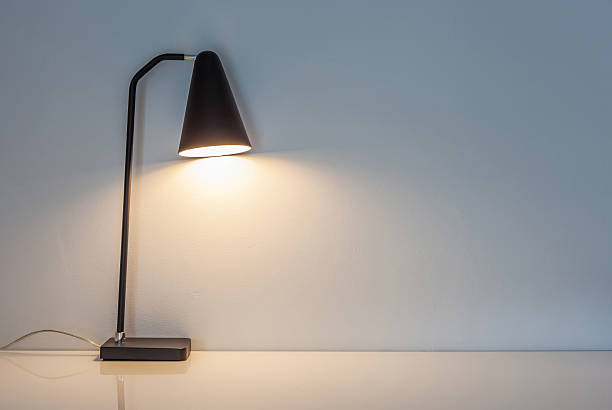 istock The modern desk lamp illuminate on the wall background. 490667970