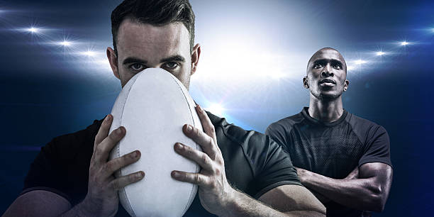 istock Composite image of tough rugby player holding ball 490668098