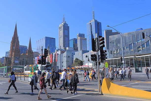 Melbourne cityscape Australia Melbourne Australia - September 26, 2015: People cross street in Melbourne downtown in Melbourne Australia. melbourne street crowd stock pictures, royalty-free photos & images