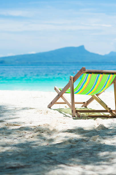 istock colorful beach chairs, clear, blue sky. 490669154