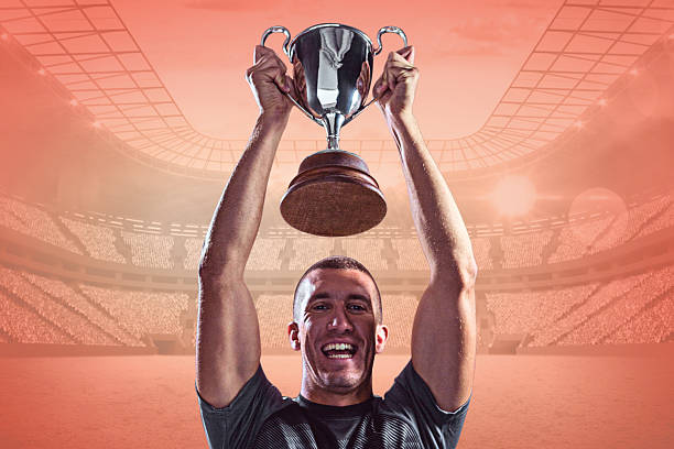 istock Composite image of cheering rugby player with winners cup 490669836