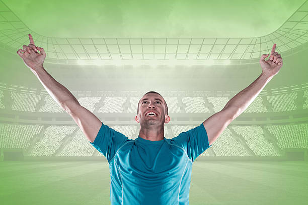 istock Composite image of happy rugby player with arms raised 490670424