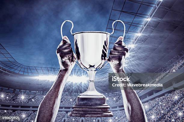 Composite Image Of Cheering Rugby Player With Cup Stock Photo - Download Image Now - Soccer, Trophy - Award, Soccer Ball