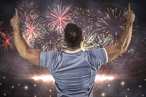 Composite image of rugby player cheering and pointing