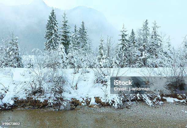 Small Winter Stream With Snowy Trees Stock Photo - Download Image Now - 2015, Canal, Cloud - Sky