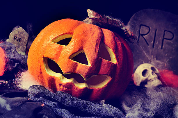 istock jack-o-lantern, skulls and gravestones 490682672