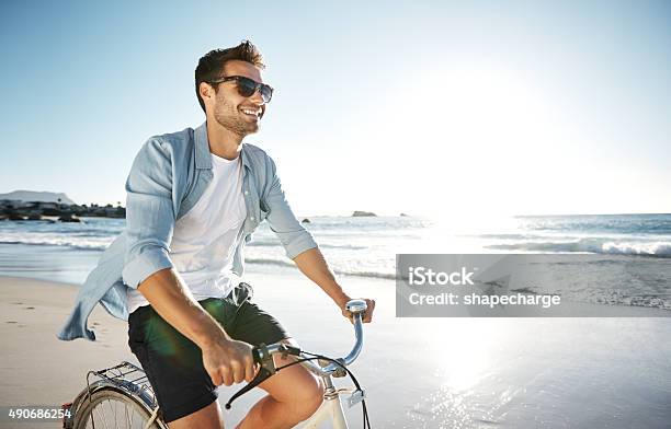 Enjoying The Therapeutic Feelings Of The Sea Stock Photo - Download Image Now - Men, Beach, Cycling