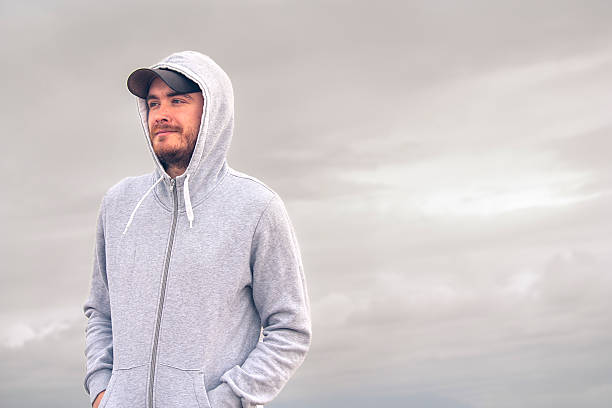 istock Young man wearing a hoodie and a baseball cap 490686342