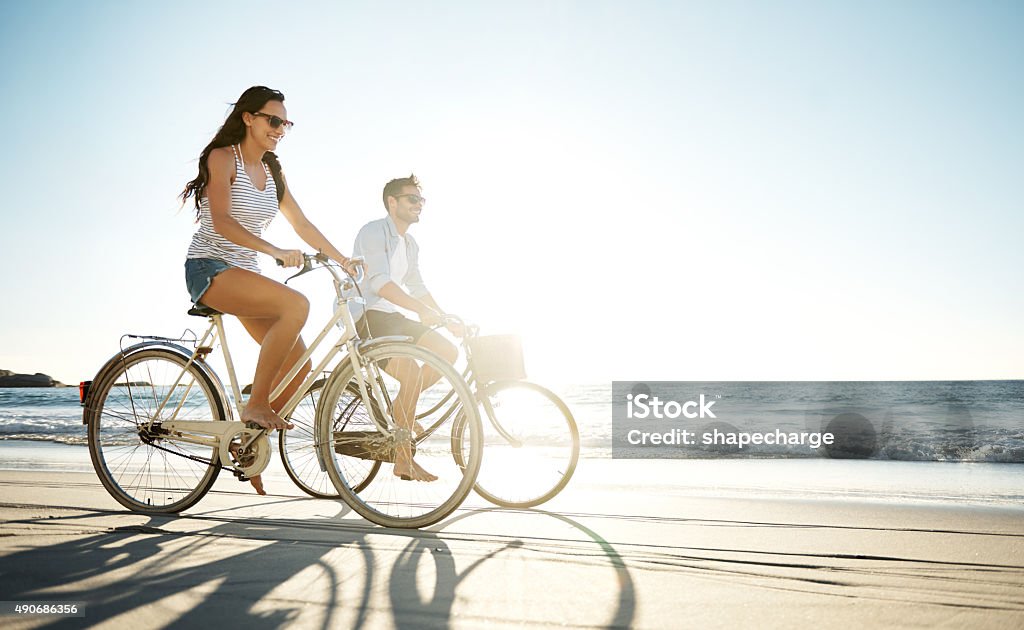 Taking a ride in the sun Full length shot of a young couple cycling on the beachhttp://195.154.178.81/DATA/i_collage/pu/shoots/805645.jpg Cycling Stock Photo