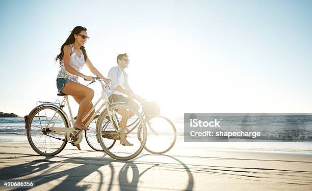 Taking A Ride In The Sun Stock Photo - Download Image Now - Cycling, Beach, Bicycle