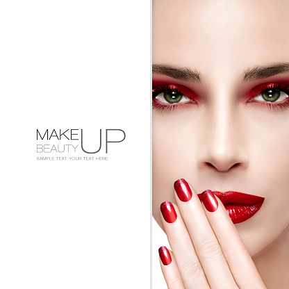 Beauty and Makeup concept. Beautiful fashion model woman with bright make-up. Trendy red lips and smoky eyes. Long eyelashes. High fashion portrait. Blank copyspace alongside and sample text. Template design