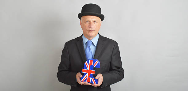 Businessman in bowler hat holding a union Jack pound sign