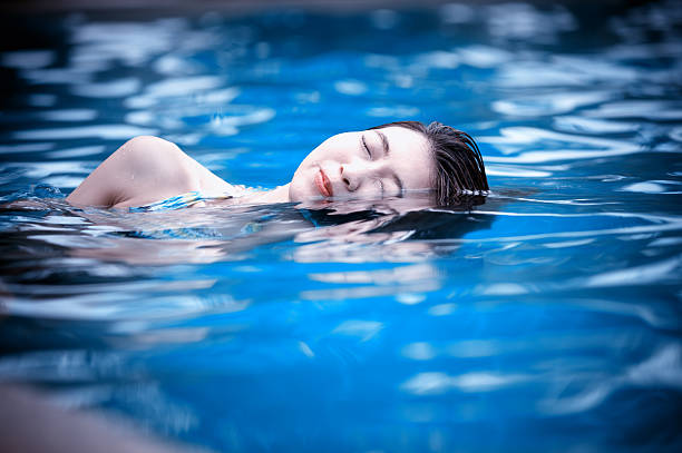 istock Young woman in the swimming pool 490686556