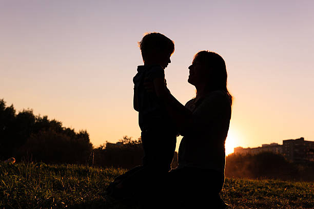 istock happy mother and little son at sunset 490686572