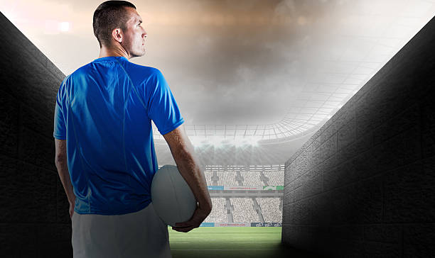 istock Composite image of rugby player looking away while holding ball 490689076