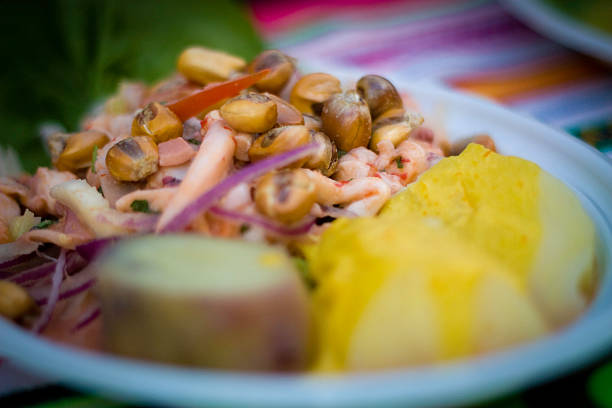 Ceviche dish with prawns, pistachios, potatoes, onion, very colorful in the foreground