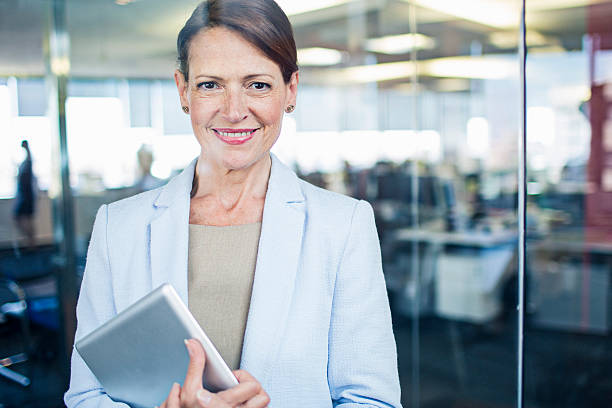 istock Businesswoman standing with digital tablet 490689316
