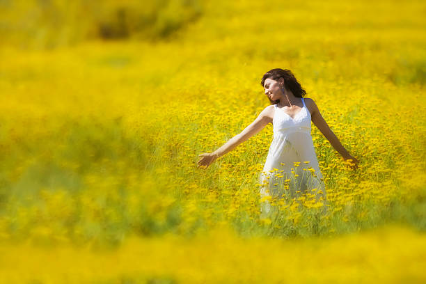 istock Young woman with spread arms looking up 490689955