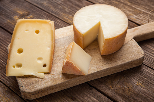 Various Cheeses on wooden background
