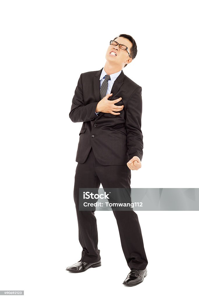 Businessman having a heart attack Businessman having a heart attack over white background Businessman Stock Photo