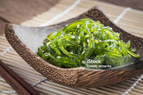 Seaweed Salad On Wooden Plate Japanese Cuisine Stock Photo - Download Image Now - Wakame, Salad, Kelp