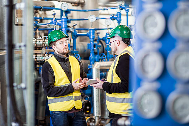 istock Male workers discussing in industry 490692672