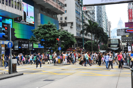 a street in Hong Kong, people crossing the road