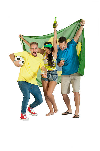 Young group of football supporters cheering with Brazil Flag stock photo
