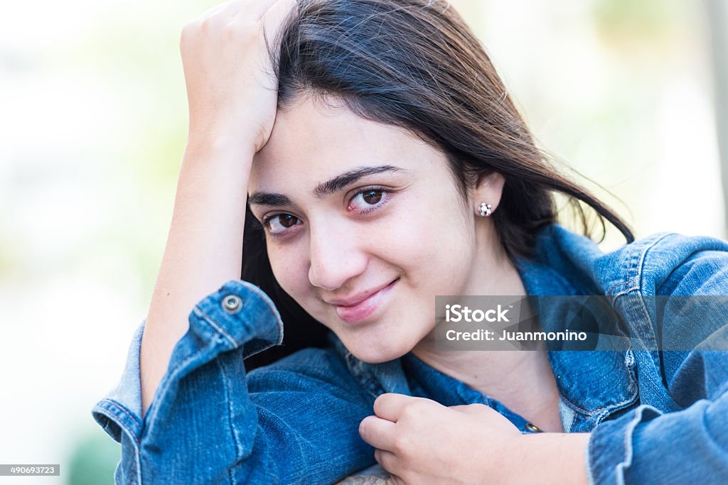Smiling hispanic teenage girl Smiling Young hispanic girl looking at the camera 16-17 Years Stock Photo