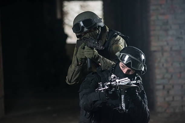 istock Fully equipped military men with automatic weapons playing airsoft strikeball 490694182