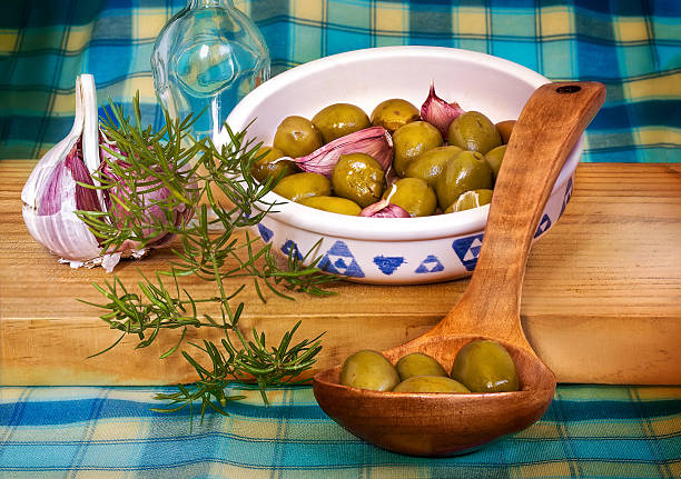 istock Green olives on a wooden spoon, Mediterranean diet 490694549