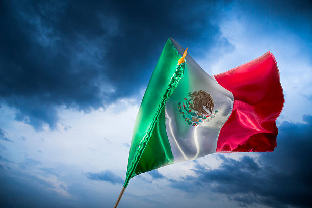 istock Mexican flag against a bright sky, independence day 490694651
