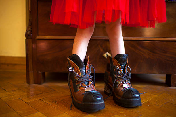 istock Girl in the big shoes 490695287