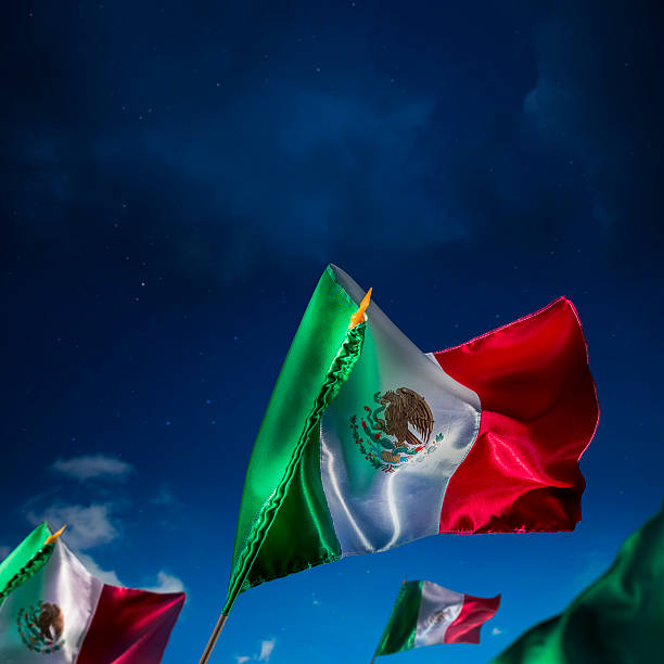 istock Mexican flag against a bright sky, independence day 490695437