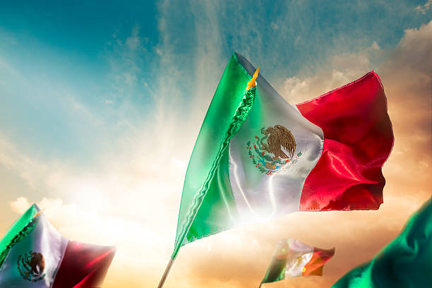 istock Mexican flag against a bright sky, independence day 490695441