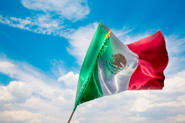 istock Mexican flag against a bright sky, independence day 490695587