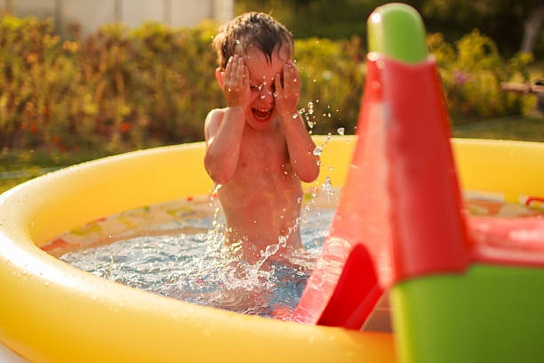 istock Happy child bathes in a pool 490697662
