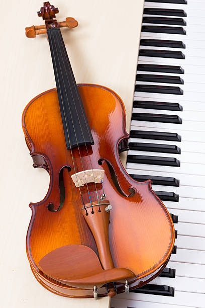 istock classical violin on piano for music background concept 490715462