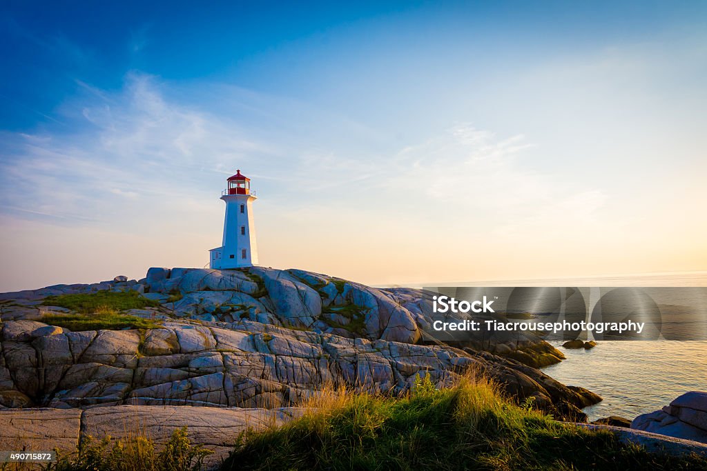 Lighthouse on the coastline. Light house on the coastline with rocky shoreline. Lighthouse Stock Photo