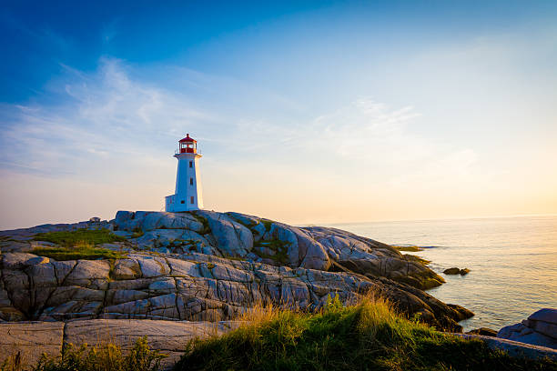 Lighthouse on the coastline. Light house on the coastline with rocky shoreline. maritime provinces stock pictures, royalty-free photos & images