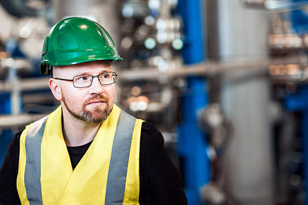 istock Thoughtful manufacturing professional standing in factory 490716008